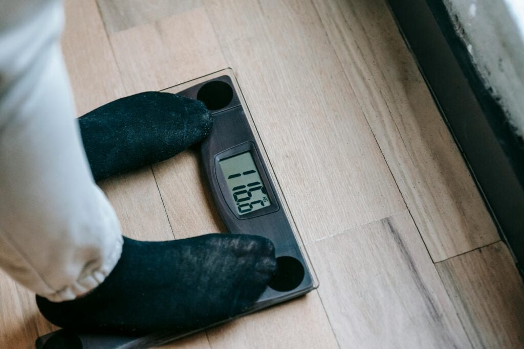 Weight management: "Measuring tape and healthy food items on a scale
