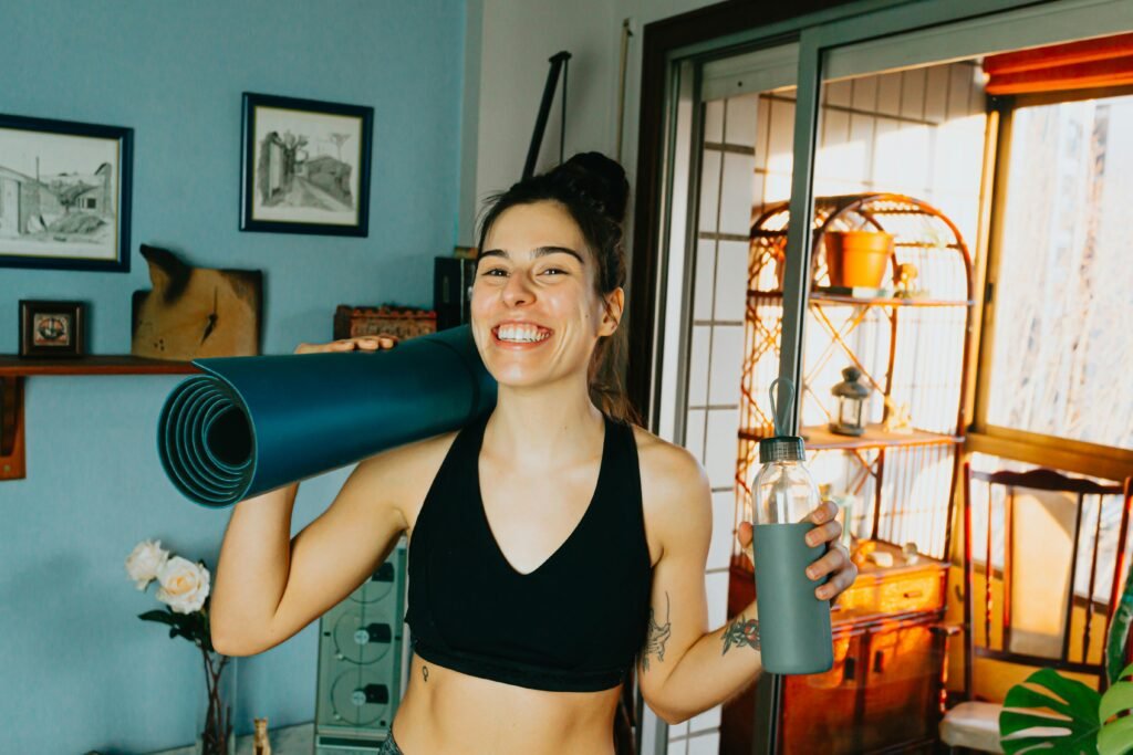 Creative workout using filled water bottles as weights for bicep curls in a home environment